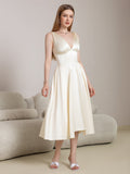 Front view of a woman in a beige satin V-neck midi dress