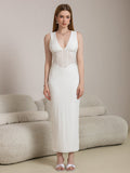 Full body shot of a woman in a white elegant maxi lace dress