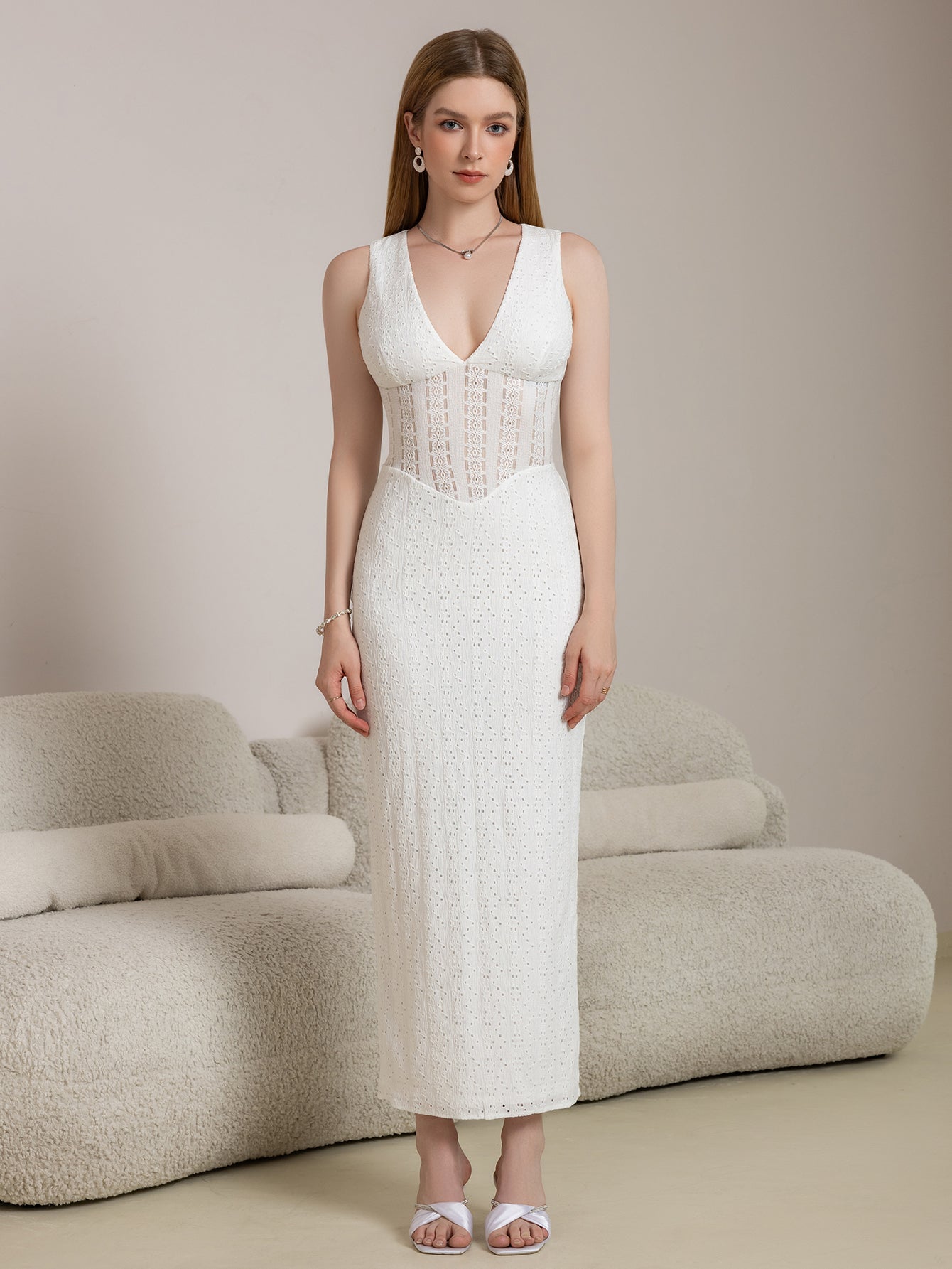 Full body shot of a woman in a white elegant maxi lace dress