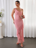 Model posing with a bouquet in a pink mesh maxi dress