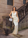 Close-up of the fabric and drape of a white satin maxi dress