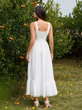 Back view of a woman in a white maxi dress with crisscross detailing