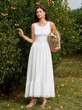 Woman holding a flower basket in a white maxi dress