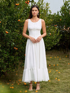 Woman wearing a white embellished button maxi dress with lace trim