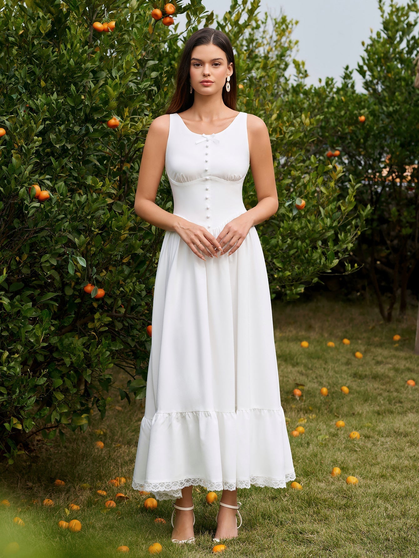 Woman wearing a white embellished button maxi dress with lace trim
