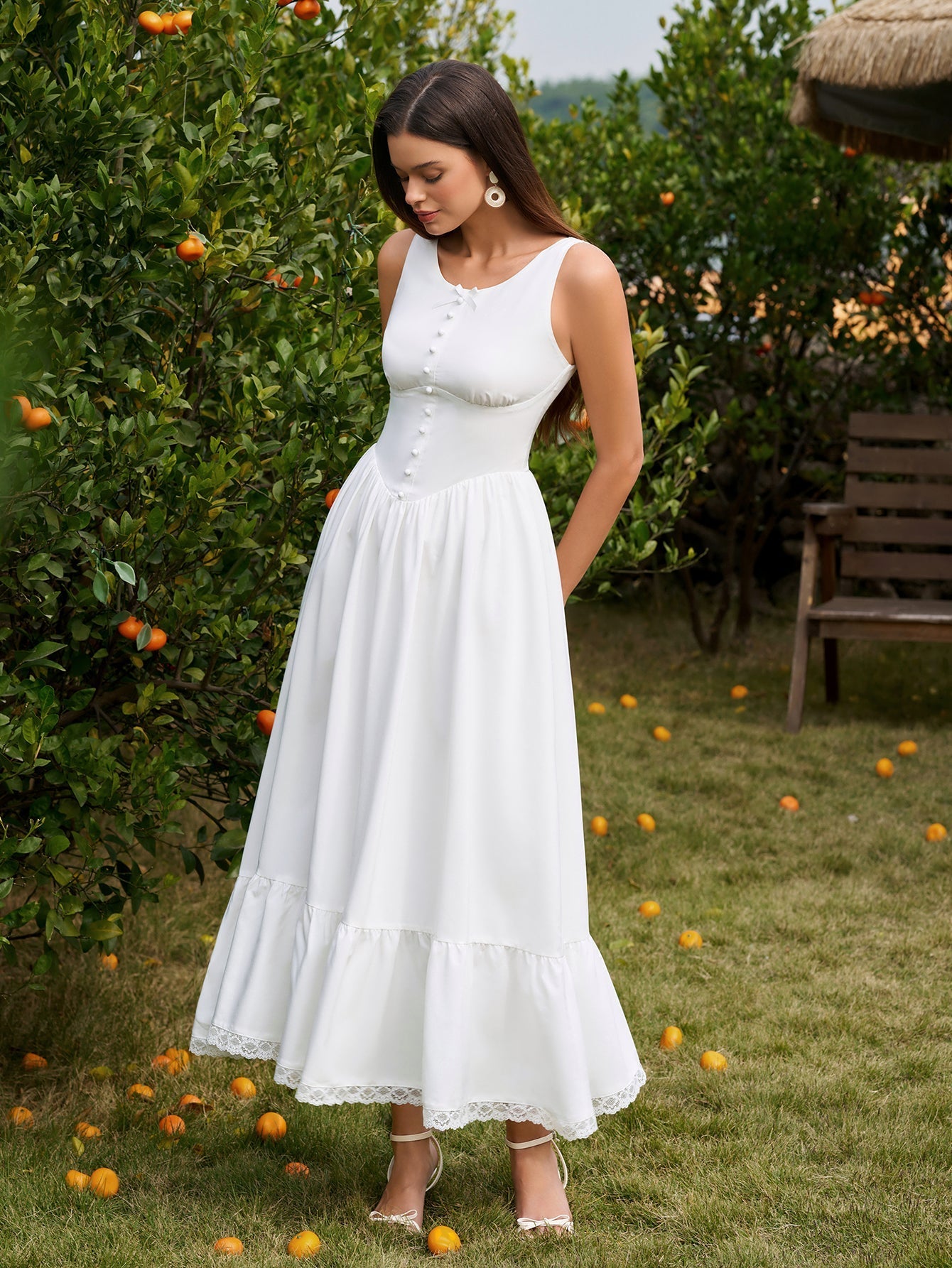 Woman posing in a white fitted bodice maxi dress outdoors