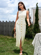 Woman wearing a beige sleeveless button midi dress with a split hem