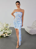 Front view of a model posing in a white and blue tie-dye strapless ruched mesh pencil dress