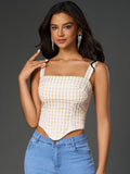 Front view of a stylish plaid print crop top paired with denim jeans