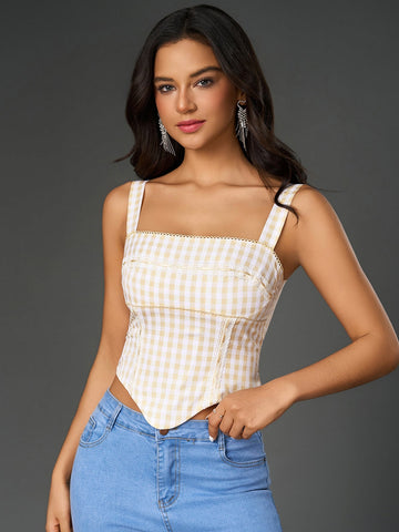 Woman wearing a yellow and white plaid print embellished crop top with wide straps and an asymmetrical hem