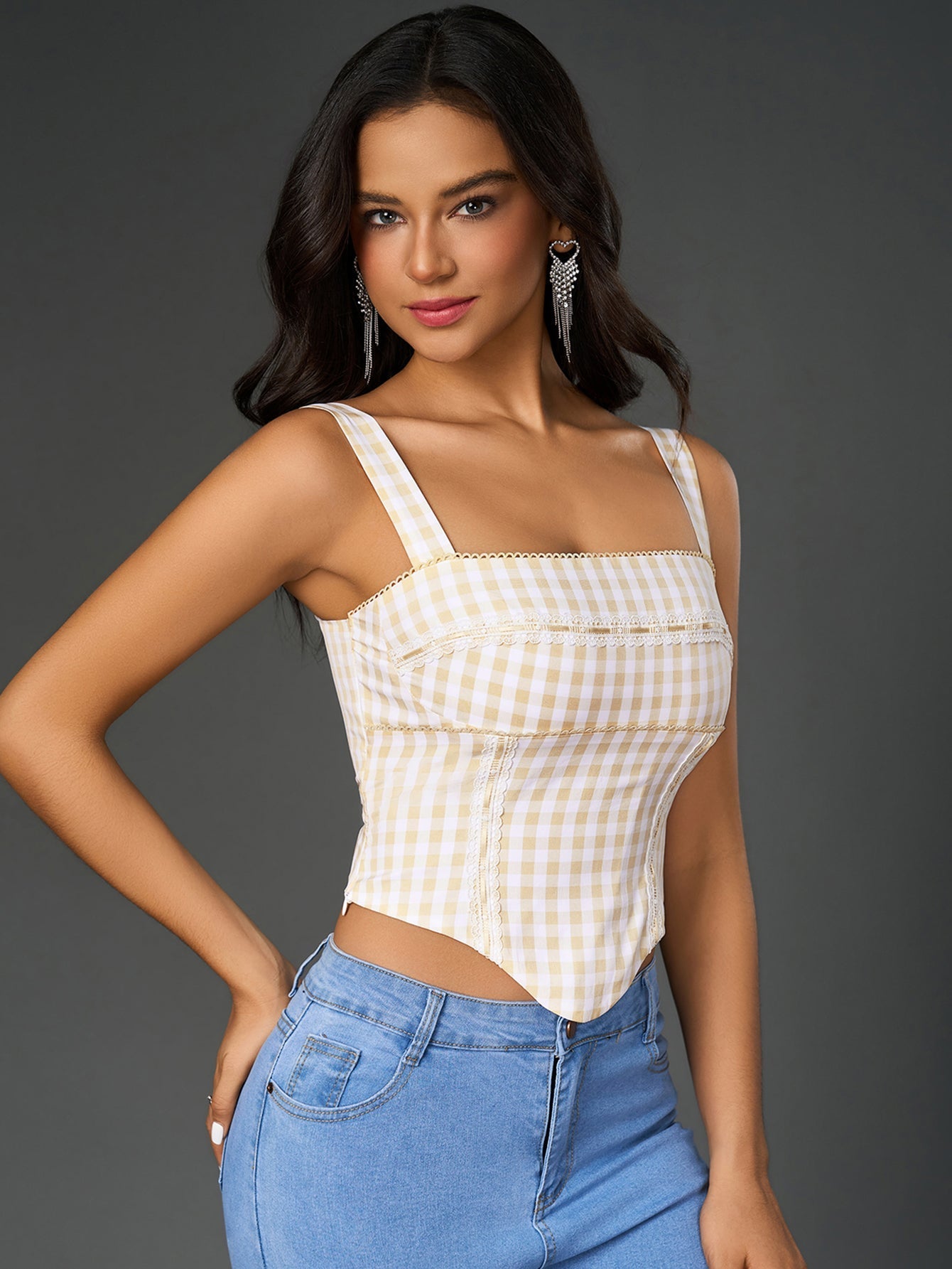 Close-up of the plaid print and embellished trim on a women's crop top