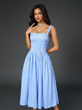 Close-up of the lace trim detail on a plaid midi dress.