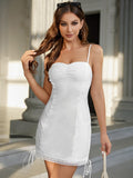 Close-up of the ruched bust and spaghetti straps on a white mini dress
