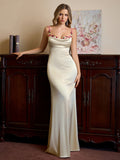 Side profile of a woman in a flowing satin evening gown