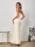 Woman wearing a beige lace strapless maxi dress from the back
