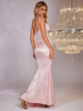 Back view of a woman in a light pink satin jacquard mermaid formal gown, showcasing the lace-up back detail.