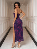 Back view of a woman in a purple and pink floral print mesh slip dress with a thigh-high slit.