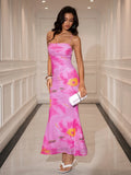 Full-length shot of a woman in a vibrant pink floral print mesh dress, showcasing the ruched bodice and flowing skirt.