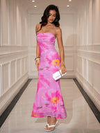 Full-length shot of a woman in a vibrant pink floral print mesh dress, showcasing the ruched bodice and flowing skirt.
