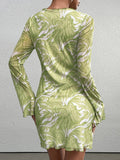 Back view of a woman in a green abstract print mesh mini dress