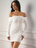 Front view of a woman in a white lace off-the-shoulder dress with long bell sleeves