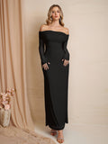 Woman wearing a black off-the-shoulder maxi dress with long sleeves.