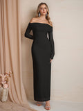Full-length shot of a woman in a black off-the-shoulder maxi dress.
