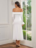 Back view of a woman in a white off-the-shoulder midi dress with ruched bodice and flared sleeves.