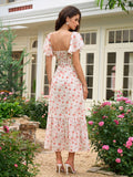 Back view of a woman in a white floral print midi dress with a smocked back panel.