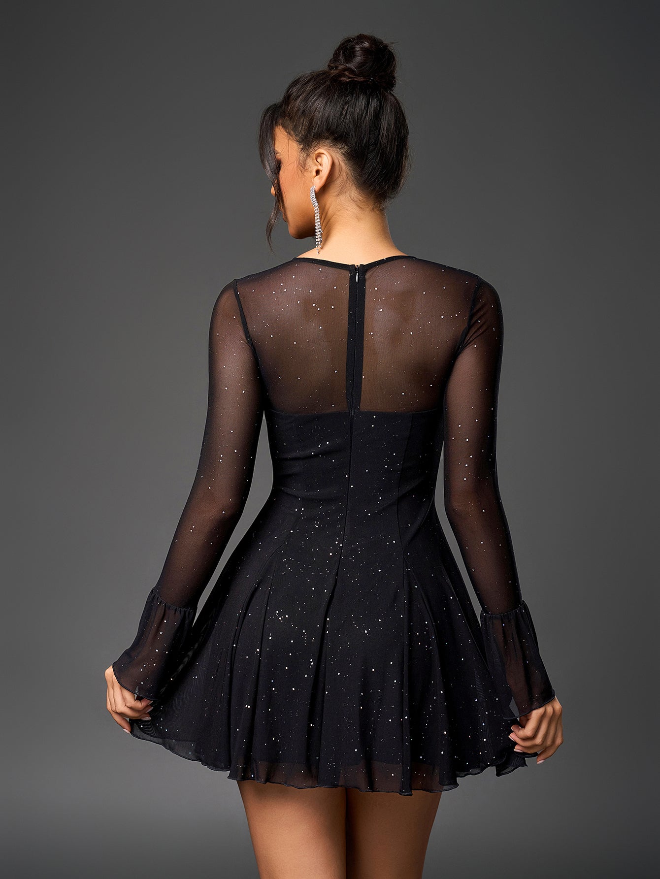 Back view of a black sparkly mesh dress with a concealed zipper