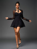 Full body shot of a woman in a black sparkly mesh A-line dress with bell sleeves and heels