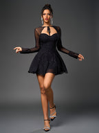 Full body shot of a woman in a black sparkly mesh A-line dress with bell sleeves and heels