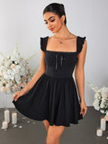 Woman wearing a black fit and flare mini dress with ruched cap sleeves and a square neckline