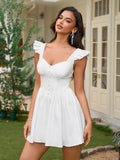 Woman wearing a white short dress with ruffled cap sleeves and a button-front bodice