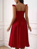 Back view of a woman in a red textured A-line midi dress with ruffled cap sleeves and a sweetheart neckline.