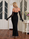 Back view of a woman in a black glitter mermaid gown with detached sheer sleeves