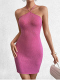 Full body shot of a woman in a pink metallic knit bodycon halter dress