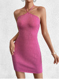 Woman wearing a pink metallic knit bodycon halter dress