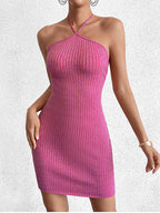 Woman wearing a pink metallic knit bodycon halter dress