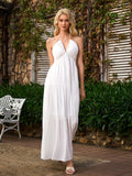 Front view of a woman in a white halter maxi dress with a plunging neckline.