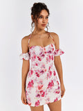 Close-up of a woman wearing a white floral print mini dress with off-the-shoulder sleeves and halter neckline.
