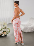 Back view of a woman in a tie-dye maxi dress with a backless design and high slit