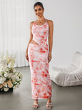 Woman posing in a pink tie-dye halter maxi dress with side cut-outs