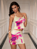 Woman wearing a yellow floral print halter neck crop top and matching mini skirt