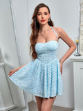 Woman wearing a light blue textured lace halter mini dress, showing off the skirt