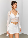 Side profile of a woman in a white cropped outfit with lace and mesh details.