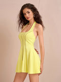 Side view of a woman in a yellow halter neck fit and flare dress