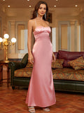 Front view of a woman in a pink satin evening gown with a ruched sweetheart neckline and halter straps.