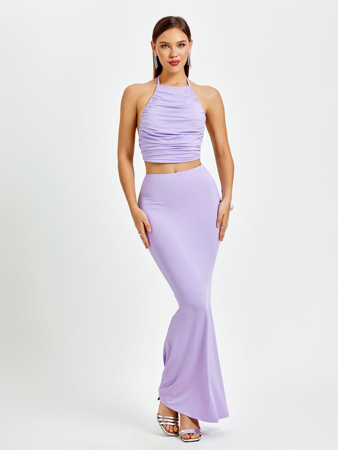 Woman wearing a lavender ruched halter crop top and a matching mermaid maxi skirt