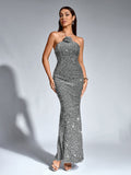 Woman wearing a shimmering silver sequined halter neck mermaid gown